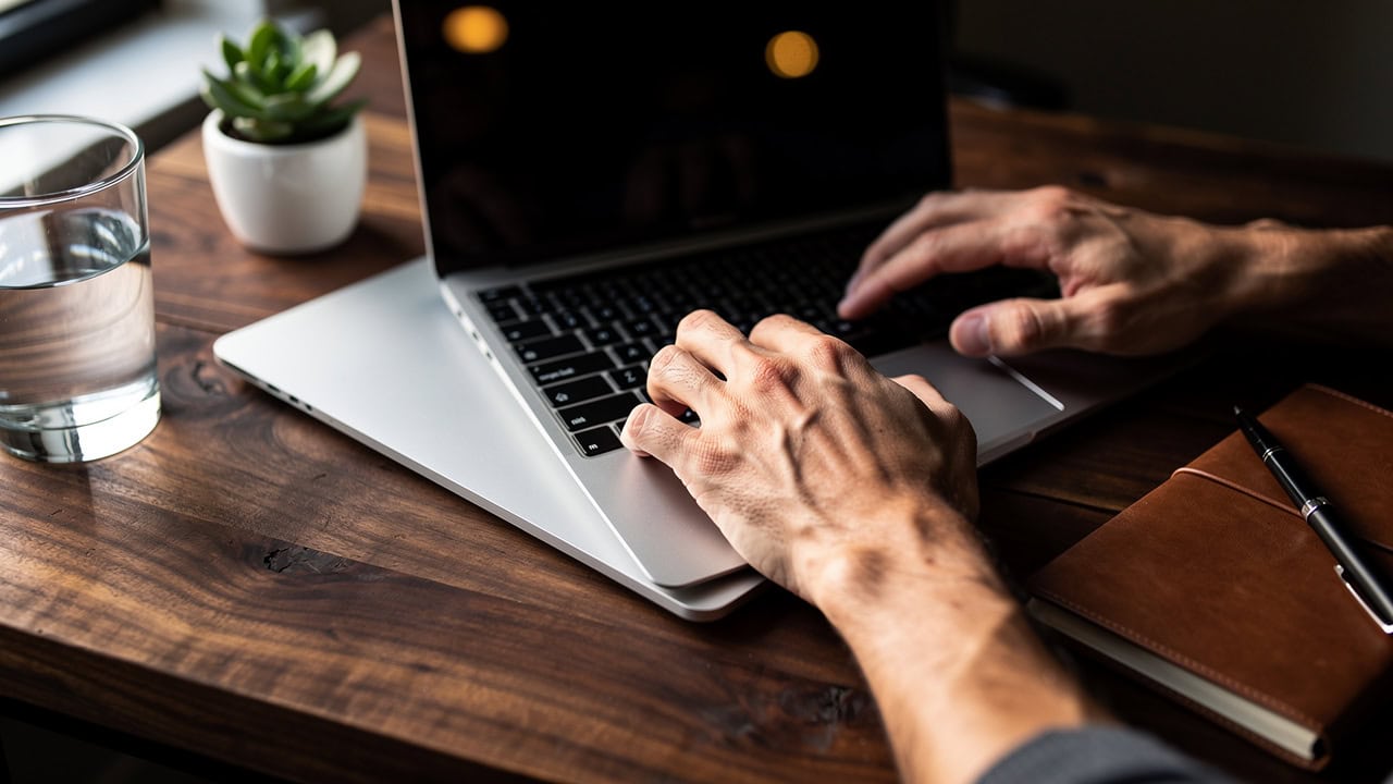 Sales rep working on CRM daily workflow at modern desk