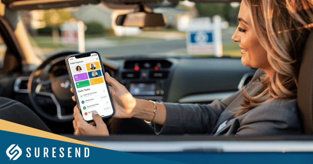 A woman sits in a car holding a smartphone, looking at a financial or banking app on the screen. She smiles while parked, with the Suresend logo visible in the bottom left corner of the image—demonstrating how seamlessly users can manage transactions and updates, much like using the Best Real Estate CRM with Pipeline Management.